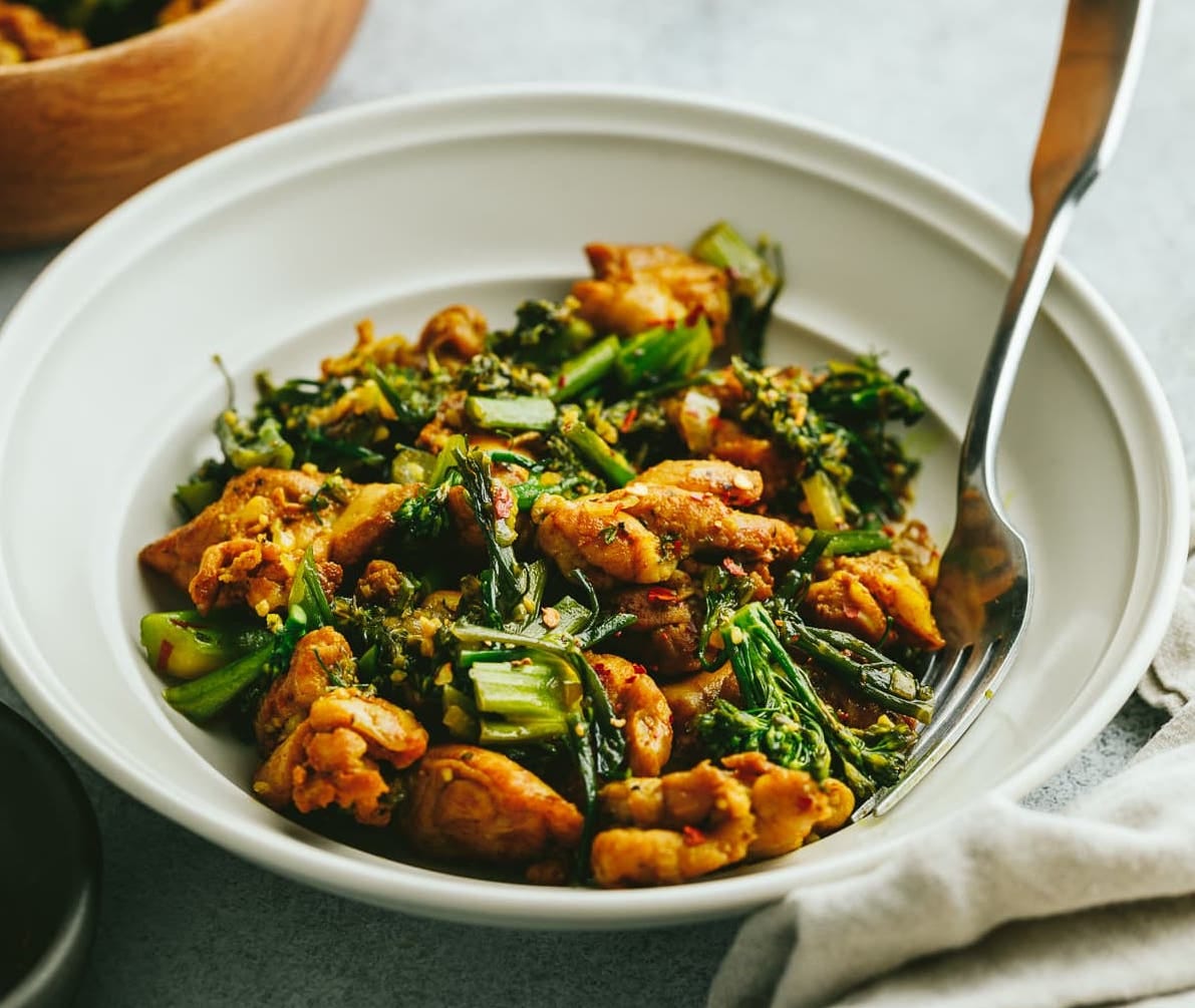 Turmeric chicken on a plate with a fork.