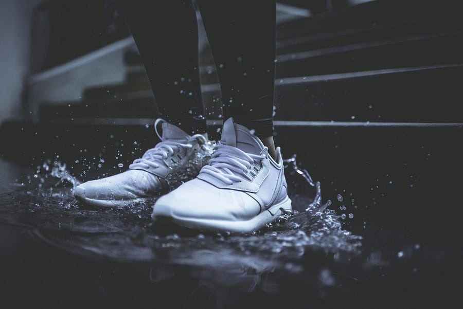 White shoes standing in water.