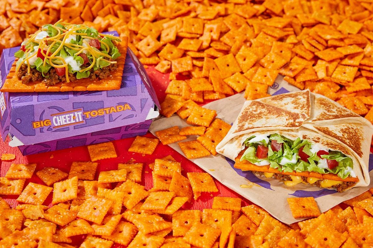 Taco Bell’s Giant Cheez-It Tostada and Giant Cheez-It Crunchwrap against a backdrop of Cheez-It crackers