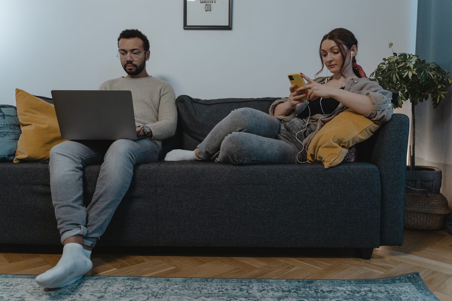 A Man and Woman Sitting on the Couch while Using their Gadgets · Free Stock  Photo