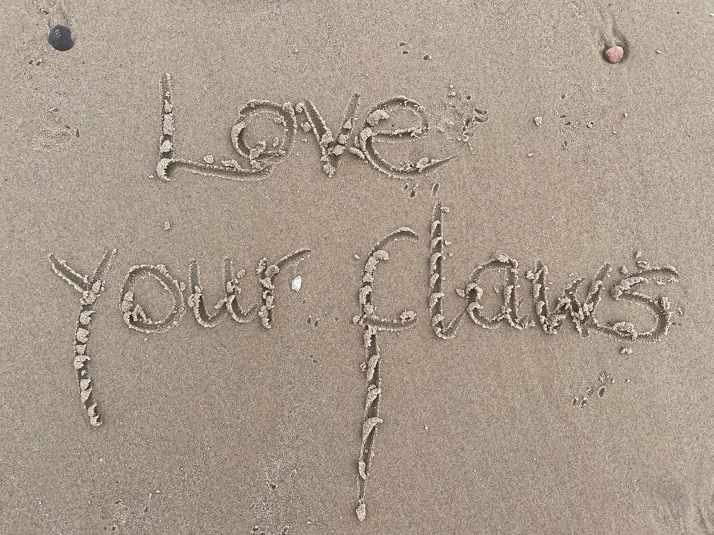love your flaws sand calligraphy