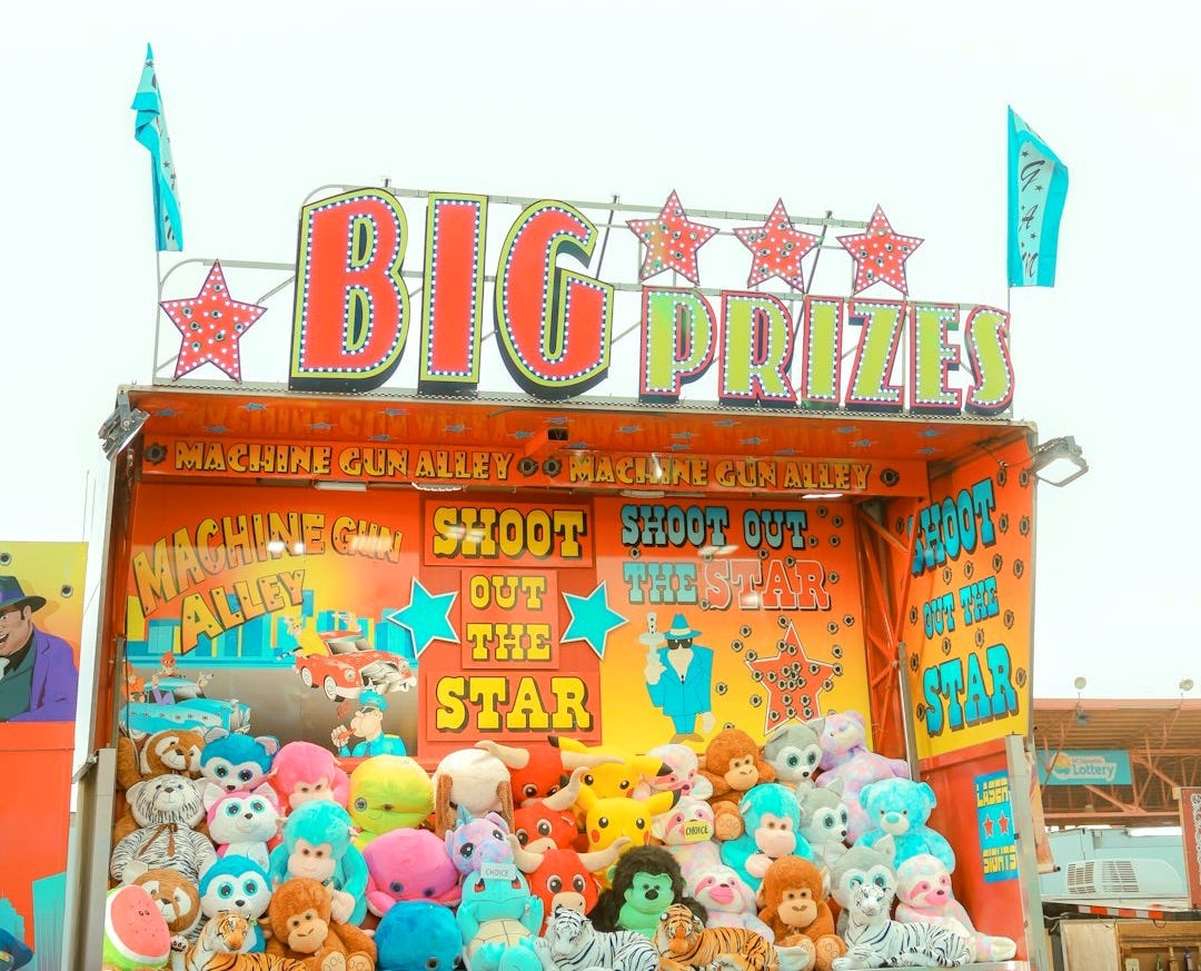 A carnival booth with lots of stuffed animals A carnival booth with lots of stuffed animals