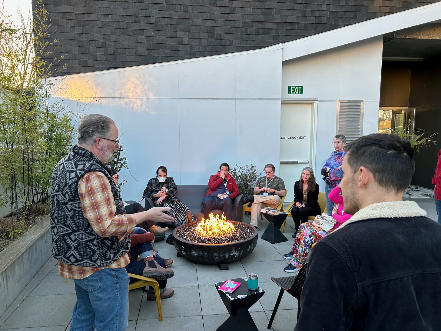 Folks sitting and chatting around a fire pit