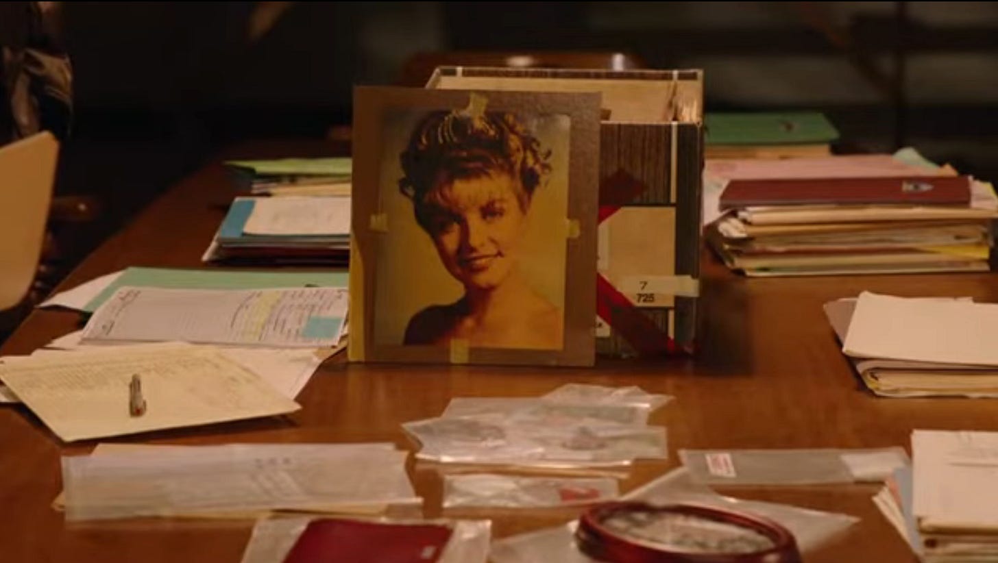 A picture of Laura Palmer propped up on a desk of papers in a screenshot from Twin Peaks the Return