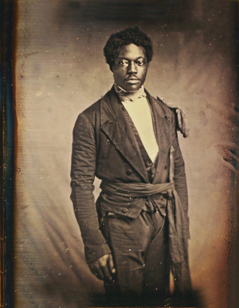 A picture of a young black man in 1860 standing wearing a suit, printed on a silvered copper plate