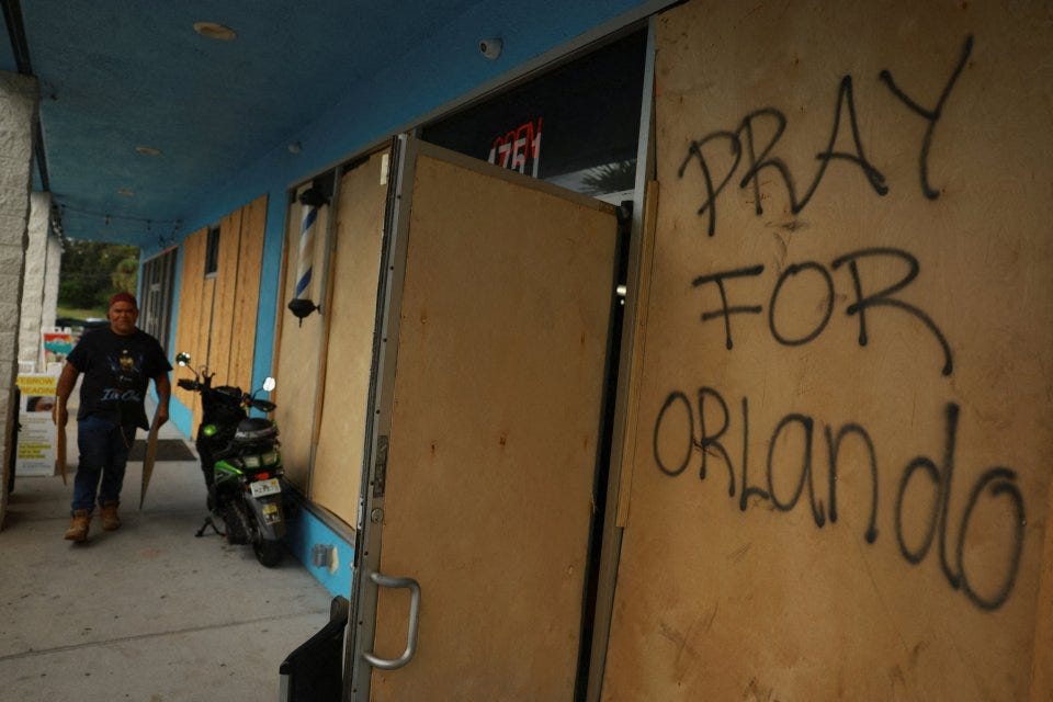 'Pray for Orlando' is written on some wood used to board up the windows at a Home Depot