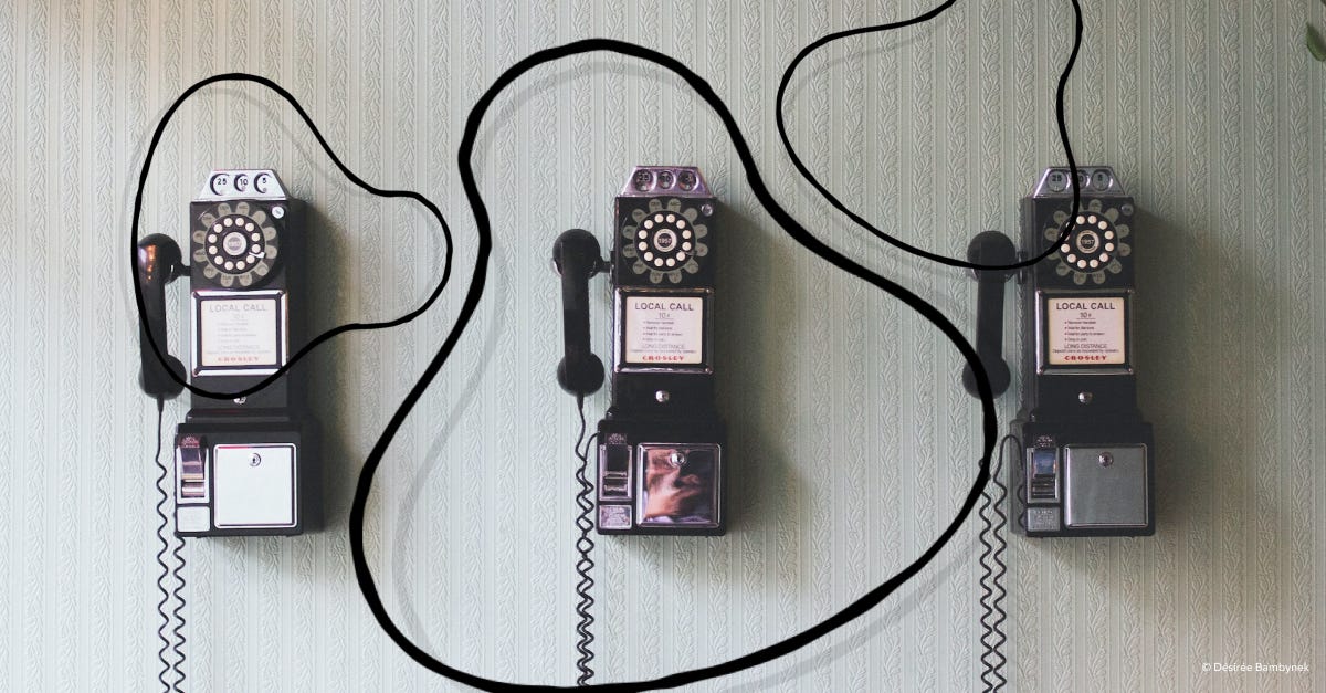 Three wall-mounted telephones
