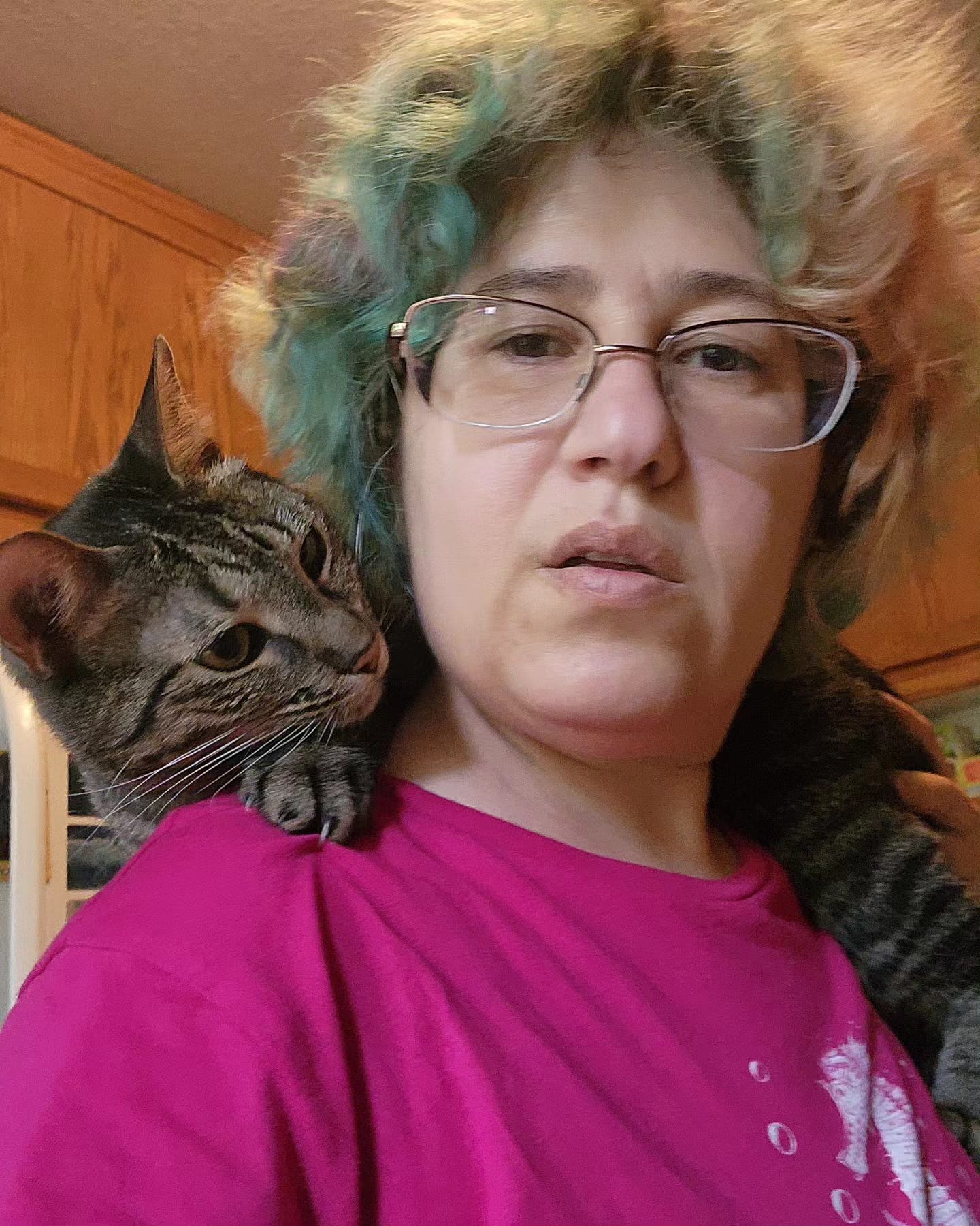 Rachel Manija Brown with a cat perched on her shoulders.