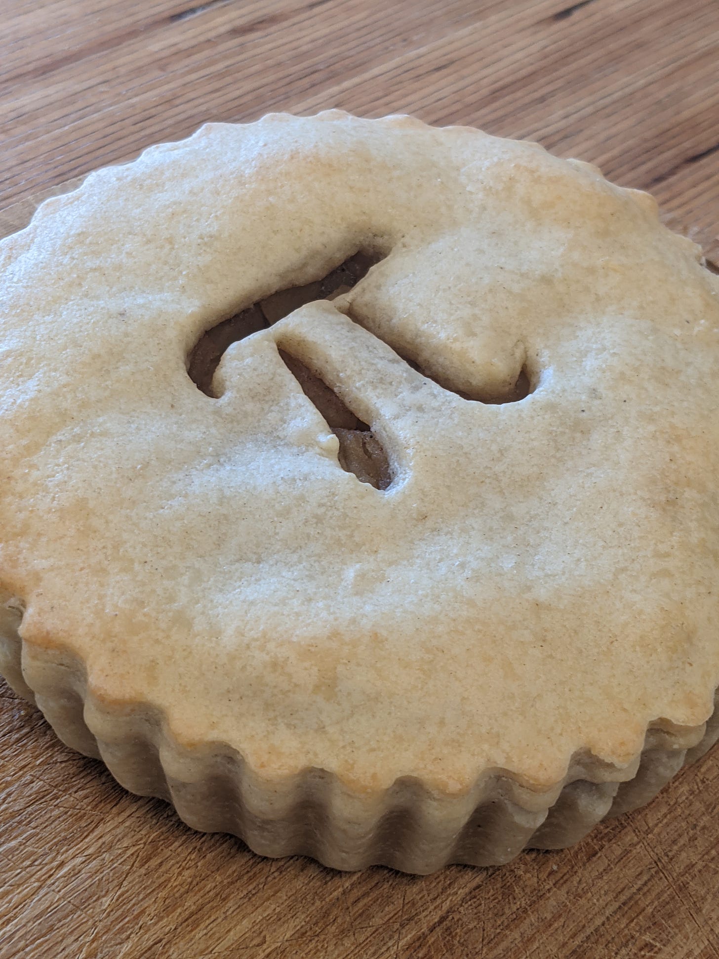 An apple pie with the mathematical symbol pi carved in it