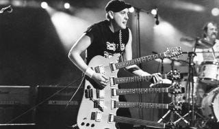 Rick Nielsen performs with Cheap Trick