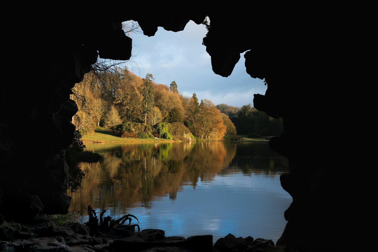 Viewing a lake from the viewpoint of a grotto that overlooks an English landscape garden. Viewing a lake from the viewpoint of a grotto that overlooks an English landscape garden.