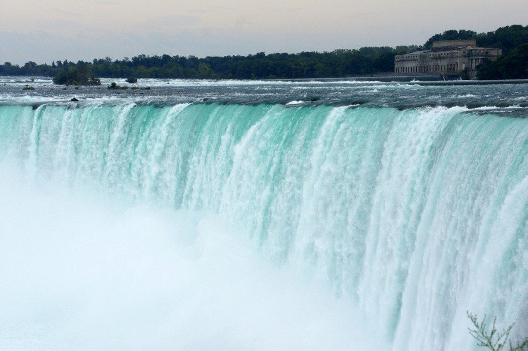 Horseshoe Falls at Niagara thunders away with the huge old electrical power plant in the distance. We got soaked from the mist and spray even far away from it.