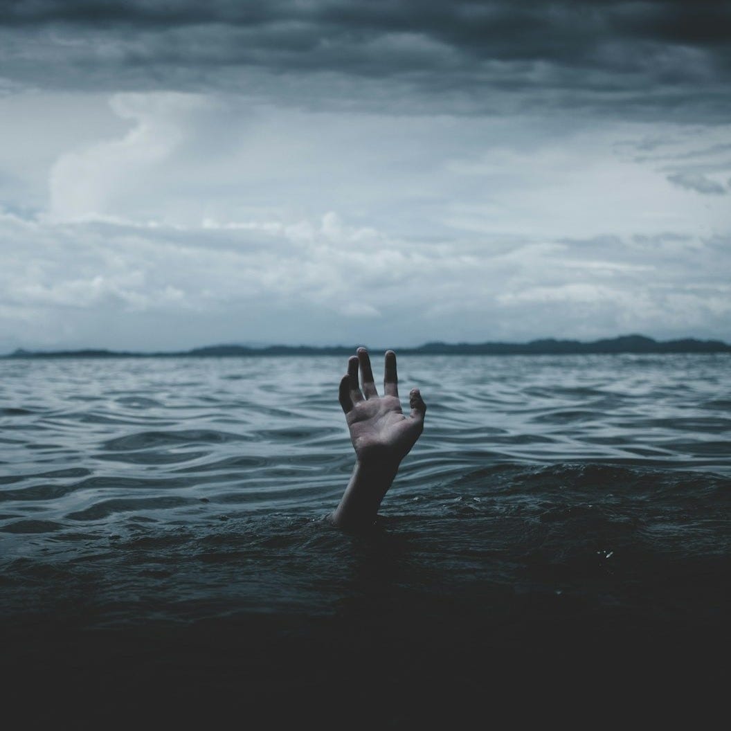 a person drowns underwater a person drowns underwater