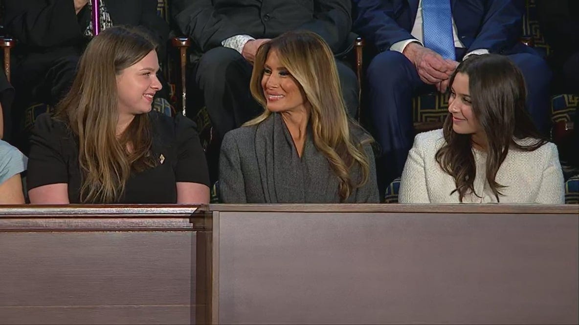 Melania Trump sits next to her guests during Trump's speech