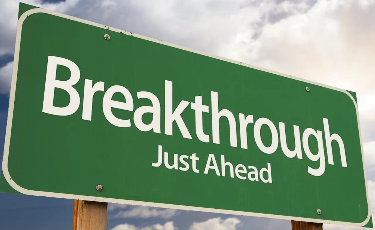 Green highway sign announcing, "Breakthrough Just Ahead!"