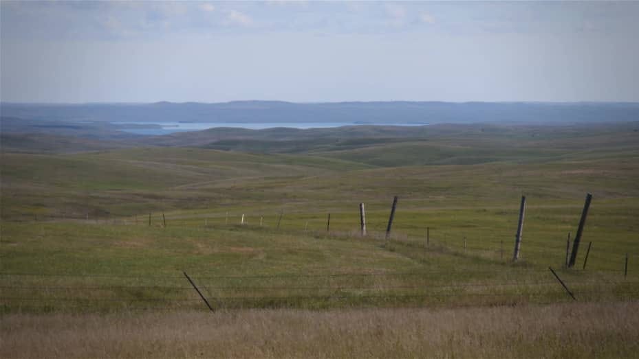 This photo shows the rangeland on the Cheyenne River Reservation with the Missouri River in the distance. The Oceti Sakowin Power Authority wants to build two wind power projects and the Ta'teh Topah project, planned to be 450 megawatts, is the larger of two wind projects. The transmission tie-line for the Ta'teh Topah project will cross the rangeland and the river to interconnect with a Basin Electric transmission line east of the Missouri River. Photo courtesy Oceti Sakowin Power Authority.