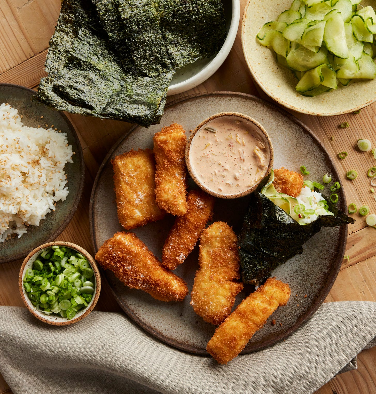 Fish stick hand rolls with fried fish, nori, kimchi mayo, rice.
