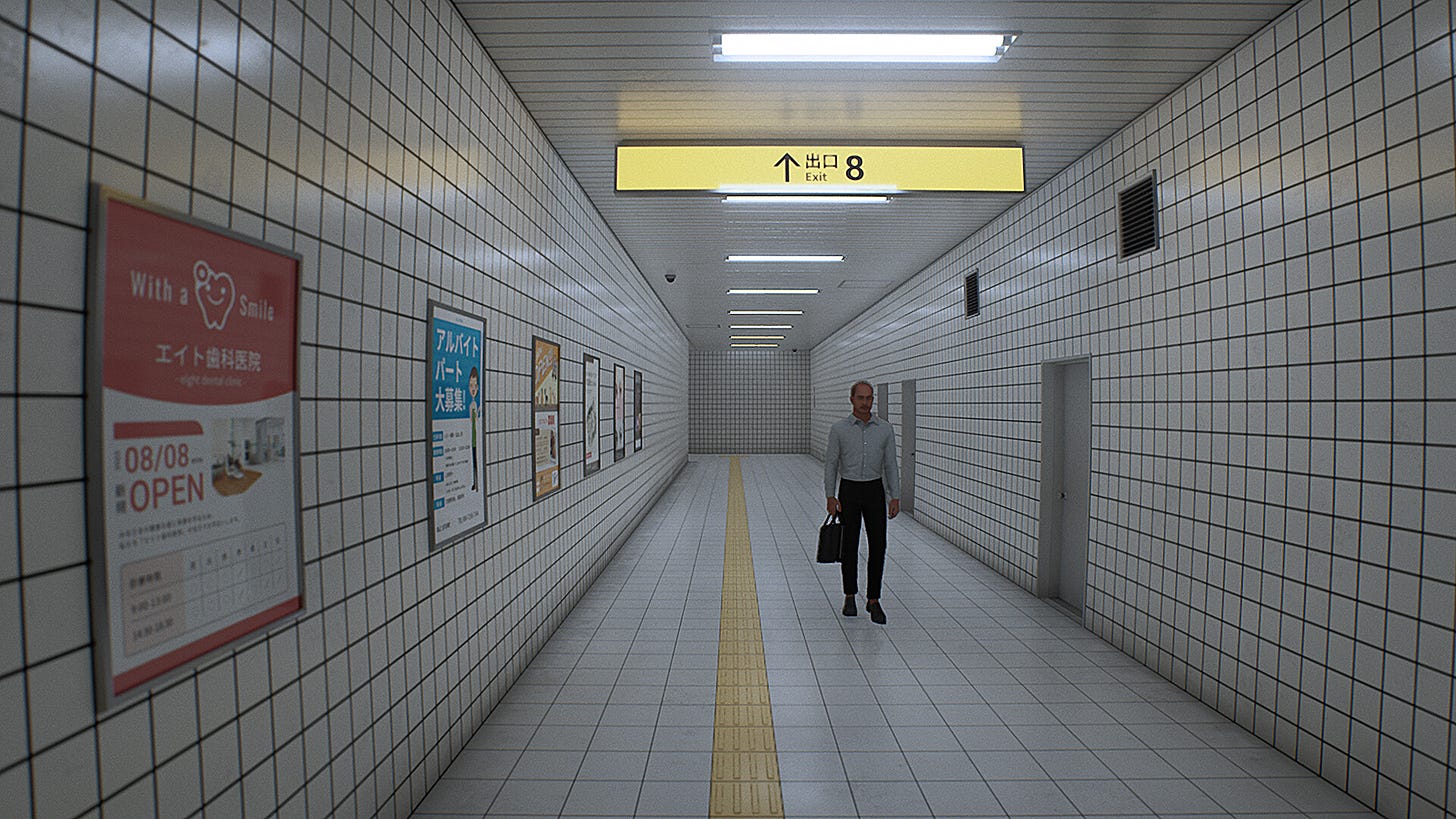 A man walks through a narrow subway corridor with posters on one side