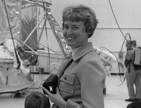 A black and white photo of a middle-aged woman with short hair smiling.