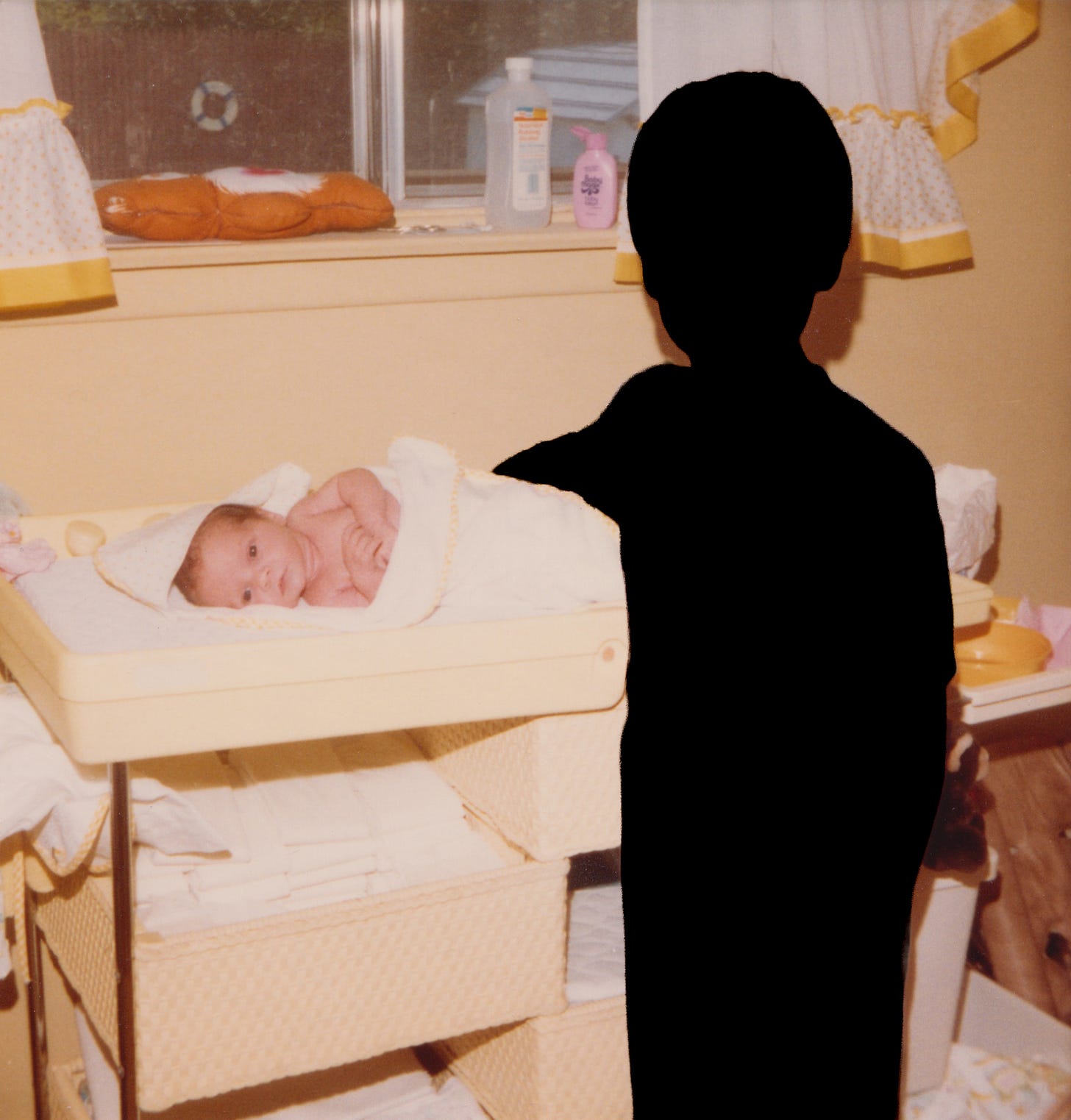 A photo of my brother and I, with him as a black silhouette. I am a baby and he is nine.