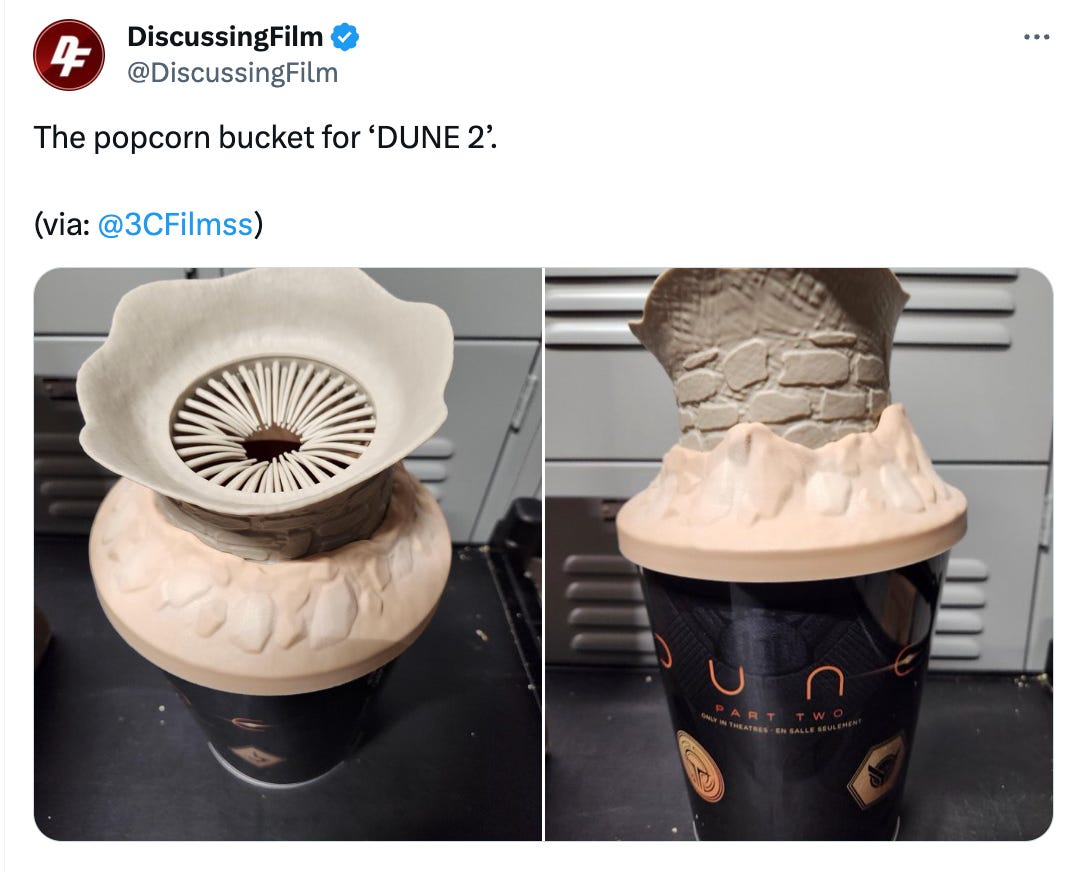 A tweet from @discussingfilm featuring the bucket. It's one of the big sandworms, and you're supposed to stick your hand in its...mouth? I guess? But it looks like a weird fleshlight.