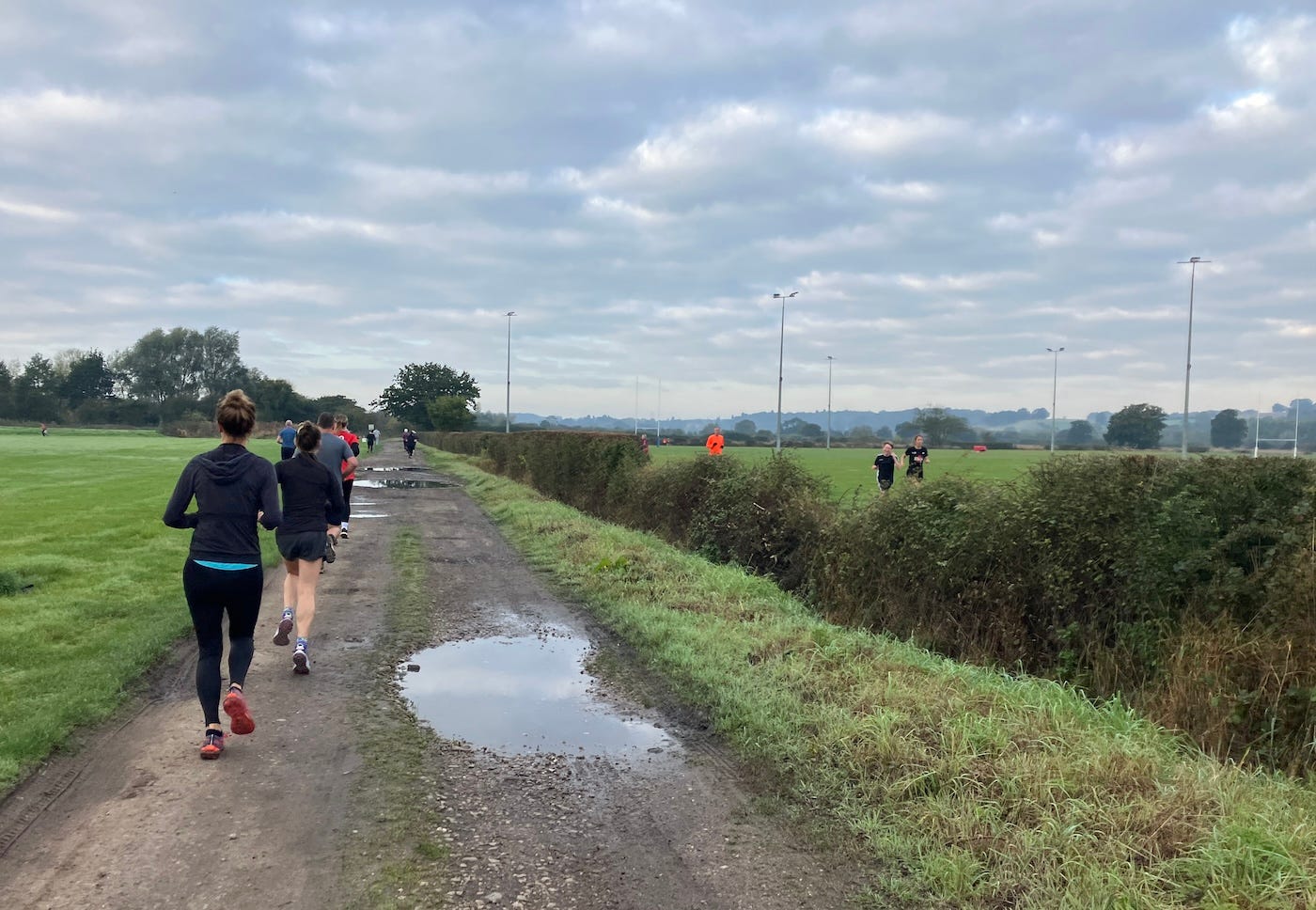 Runners at different points on the route, either side of a hedge