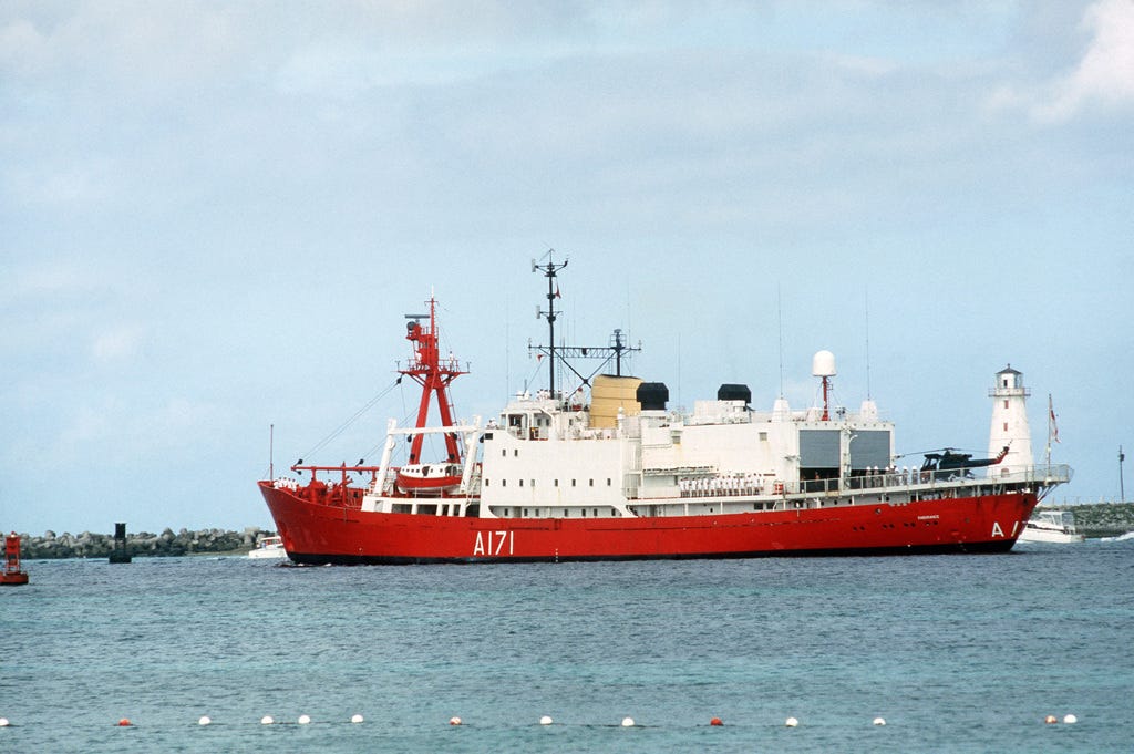 A port-side view of HMS Endurance showing off her handsome red hull and bright white upper works. She looks fairly unimposing.