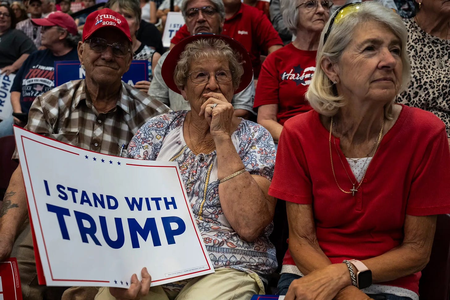 Trump followers look on with skepticism at a rally.  From: “How Trump’s Verbal Slips Could Weaken His Attacks on Biden’s Age.”  The New York Times. Oct. 30, 2023. Caption: Mr. Trump’s speaking style has often meant that his supporters, or voters who are open to backing him, hear what they want to hear from him. Photo: Jordan Gale for The New York Times. 