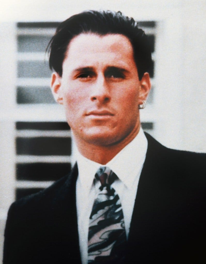 Family photo of Ronald Goldman, man in a suit and tie, from a press conference following his murder in 1994