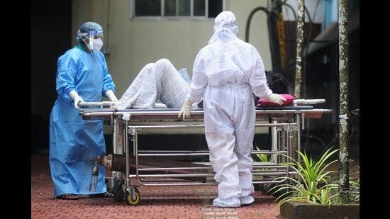 Health workers wearing protective gears shift a man with symptoms of Nipah virus to an isolation ward at a government hospital, in Kozhikode in Kerala on Saturday. (AFP)