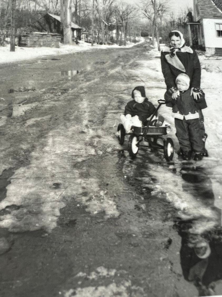 Mother with two children in snow in 1955