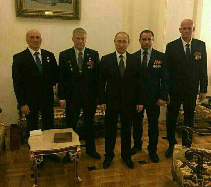 Vladimir Putin (center) with Dmitry Utkin (far right) and other Wagner commanders, 2016