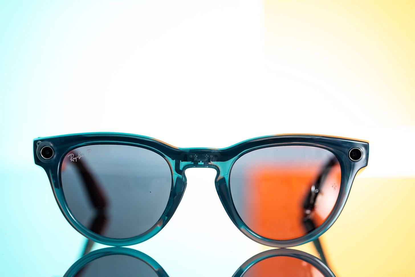 Front view of the Ray-Ban Meta smart glasses on a colorful background