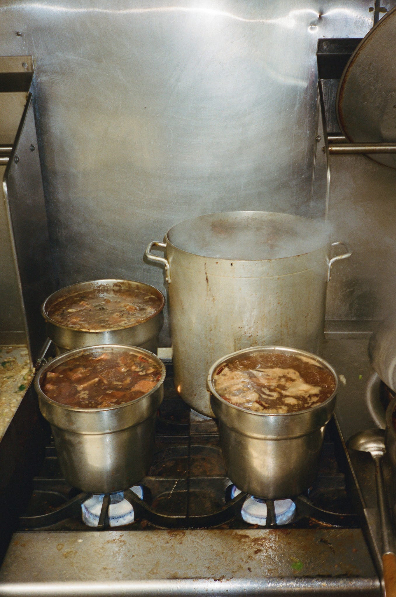 Simmering pots of beef noodle soup