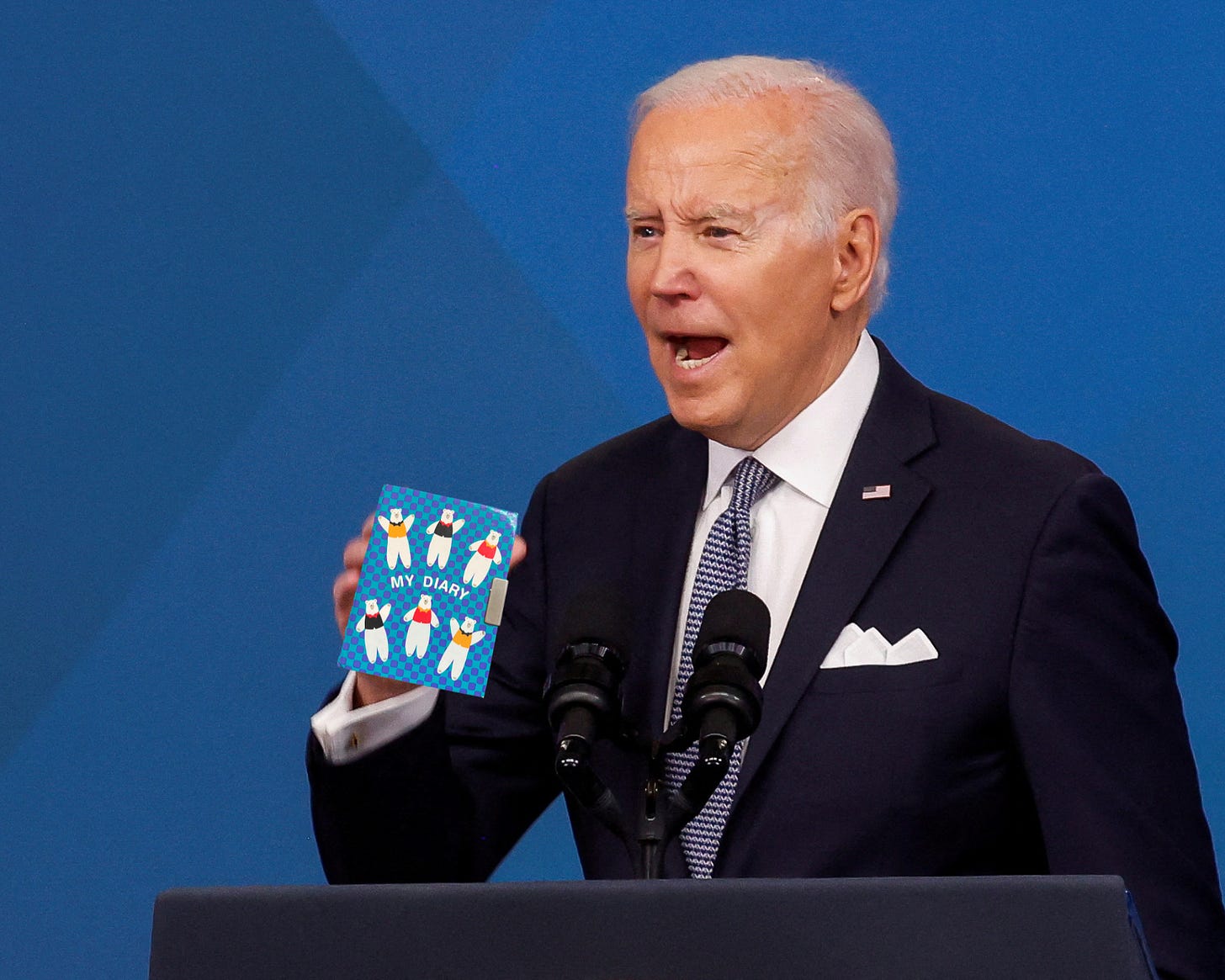 Edited image of Joe Biden speaking at a podium while holding Amber Tamblyn's childhood diary.