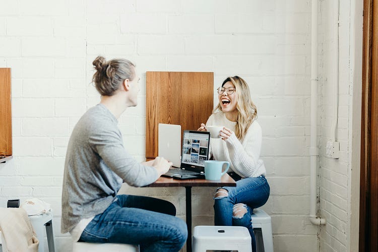 couple sitting at a table and talking.