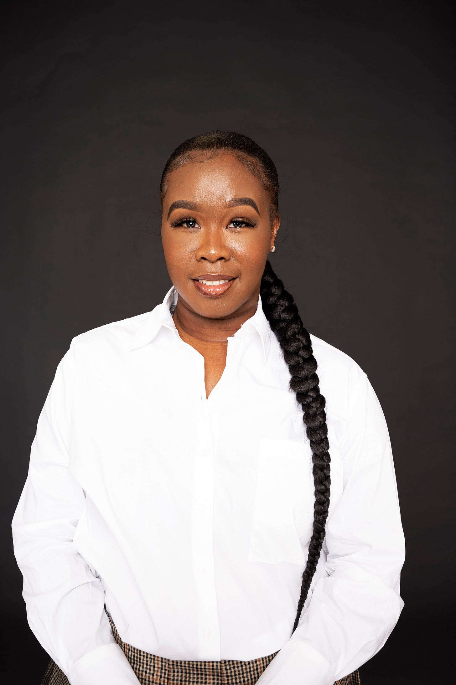 Young black woman with white shirt and single braid to side