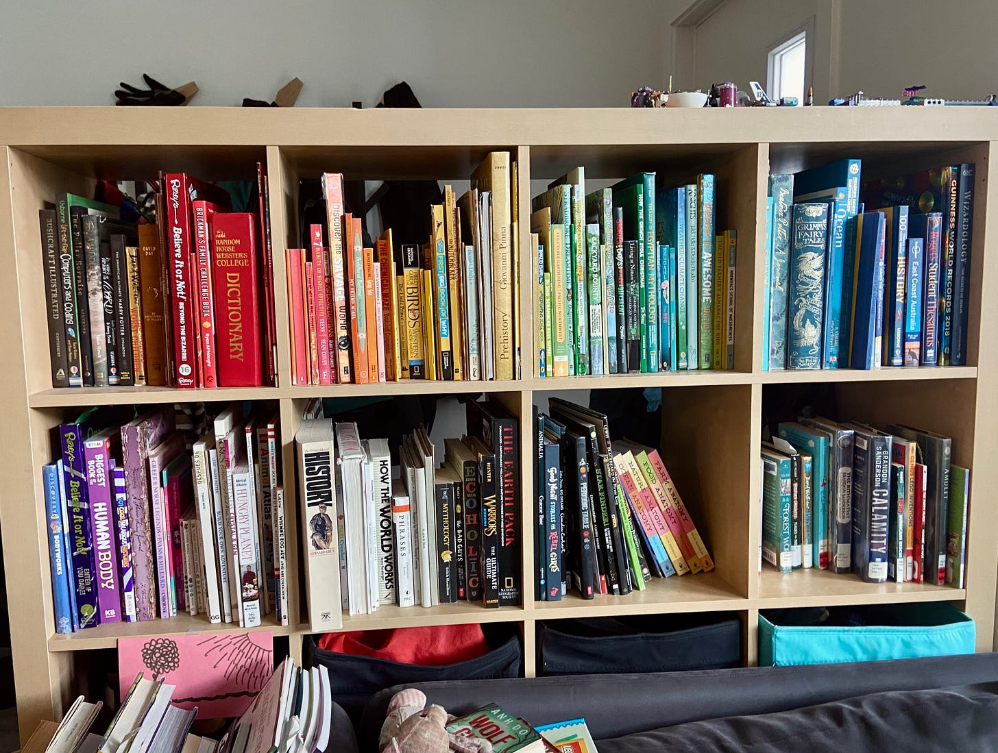 A bookshelf full of colorful books for homeschooling kids to use.