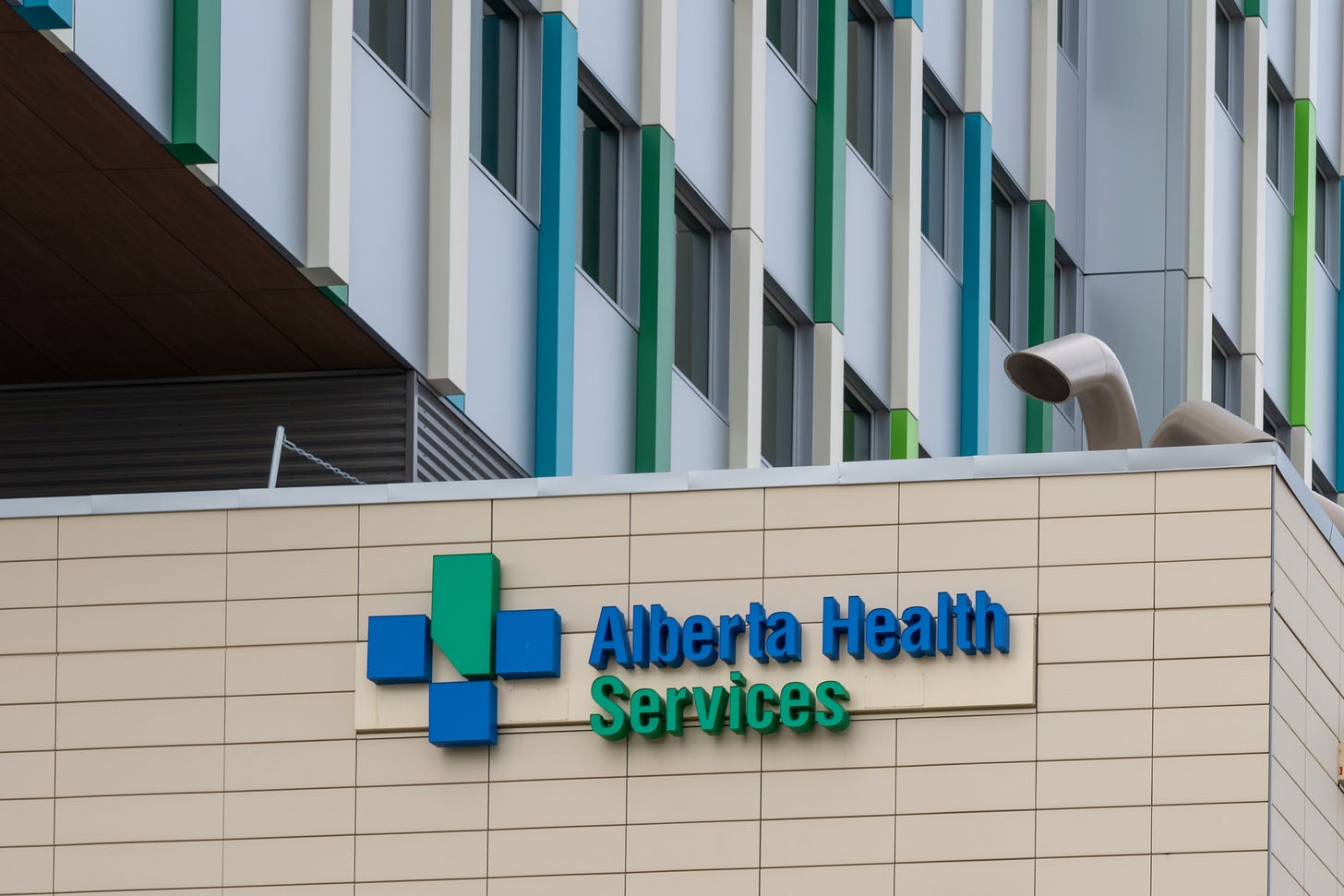 Alberta Health Services sign on the side of a building in Calgary.