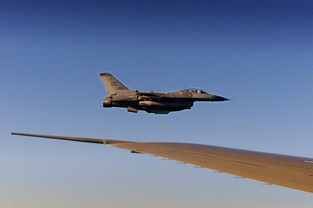 AIR FORCE ONE,- SEPTEMBER 11: An F-16 fighter flies just off the wing of Air Force One on a flight back to Washington 11 September 2001. Bush returned to the White House where he will address the nation from the Oval Office on the terrorist attacks at the World Trade Center and the Pentagon. (Photo credit should read DOUG MILLS/AFP/Getty Images)