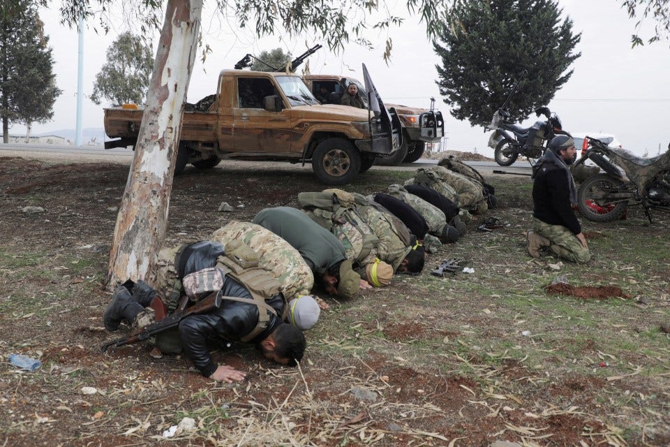 Rebel fighters pray in Homs countryside