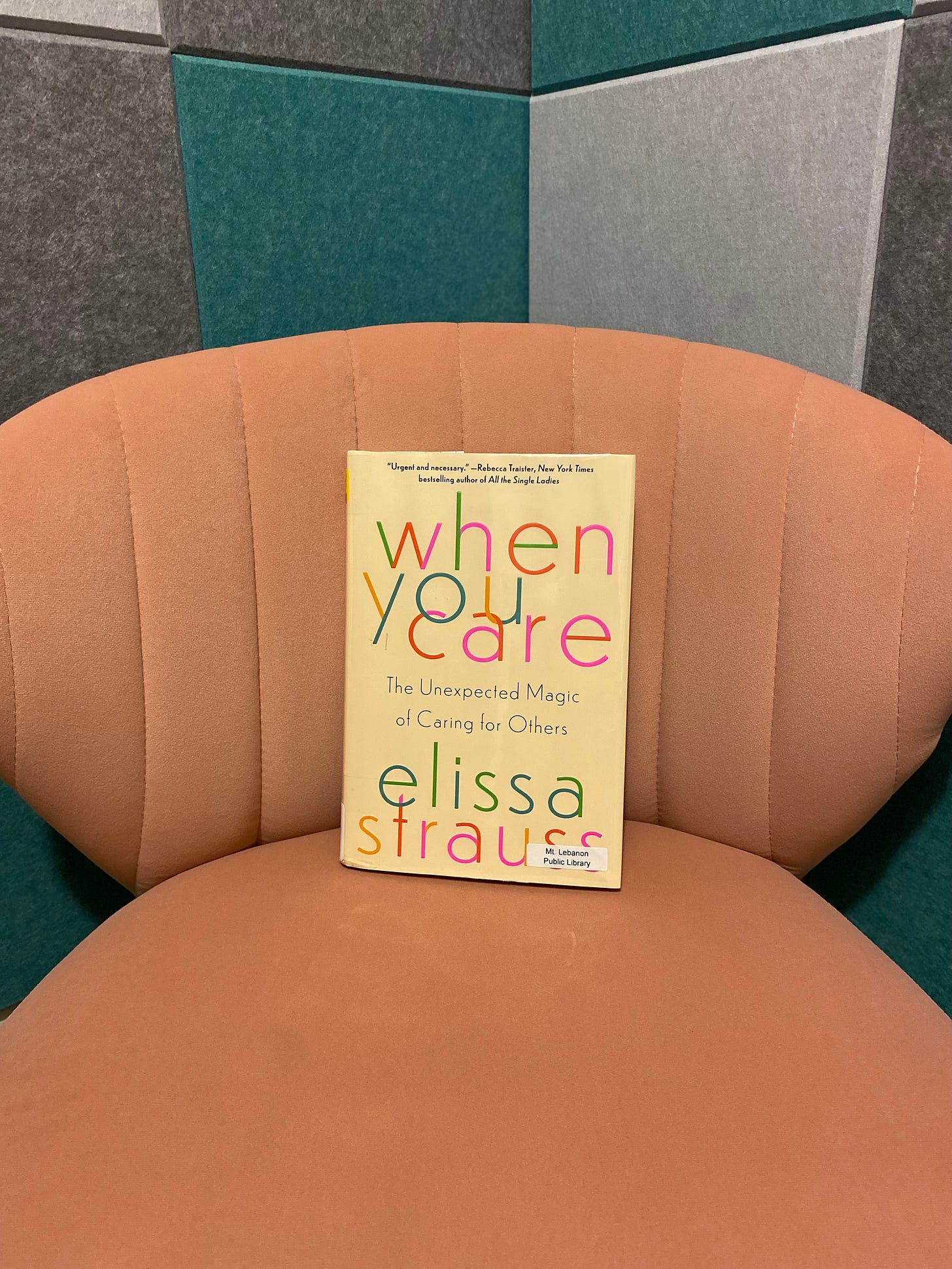 Book titled When You Care by Elissa Strauss in pink chair