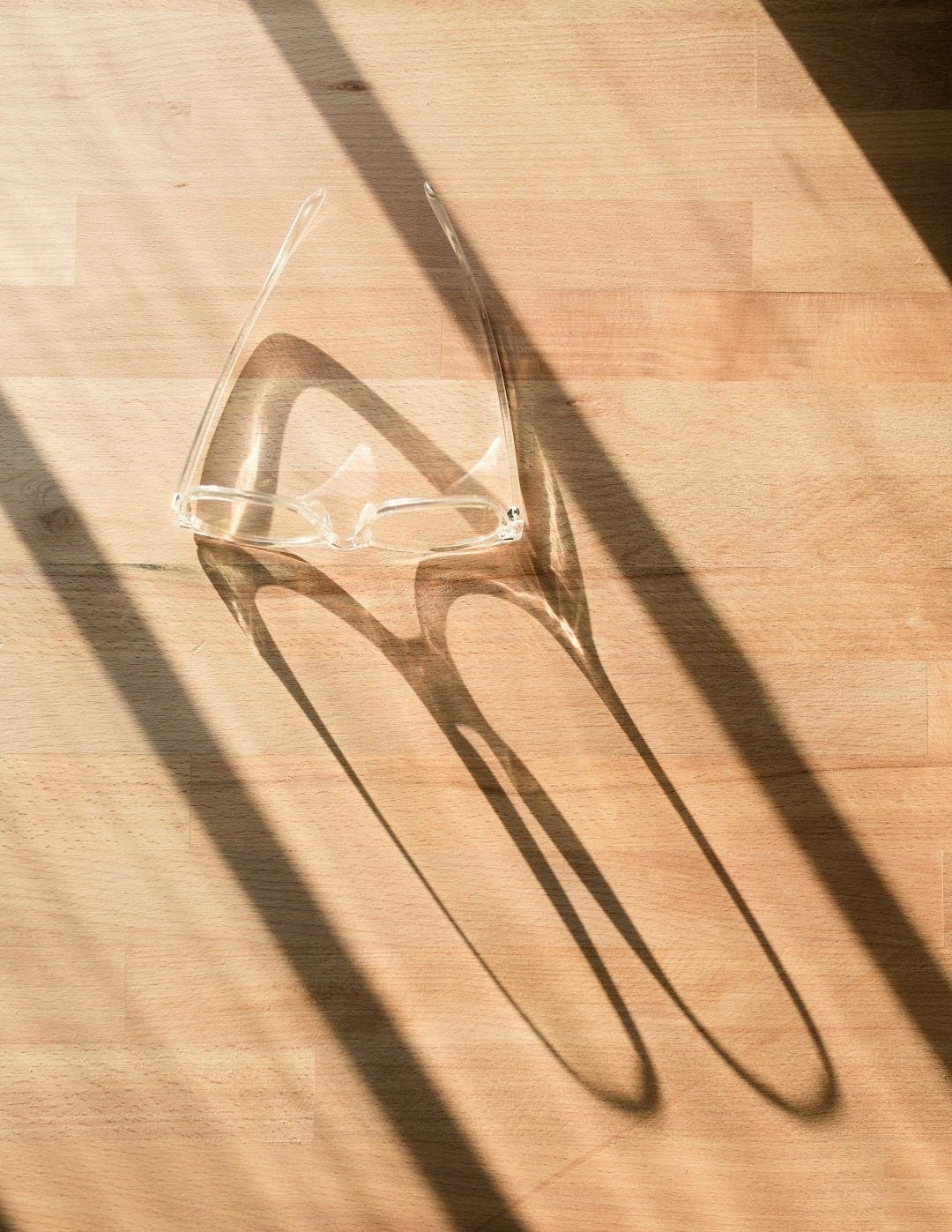 a pair of sunglasses on a wooden surface