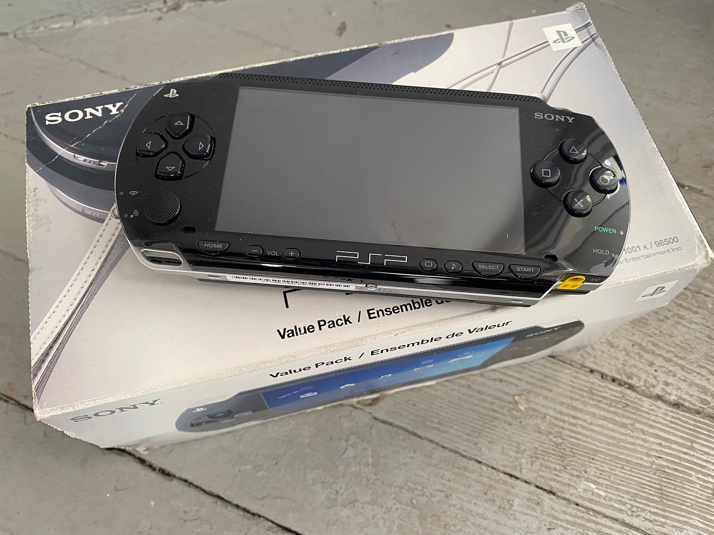 Photo of a PlayStation Portable resting on the box it came in