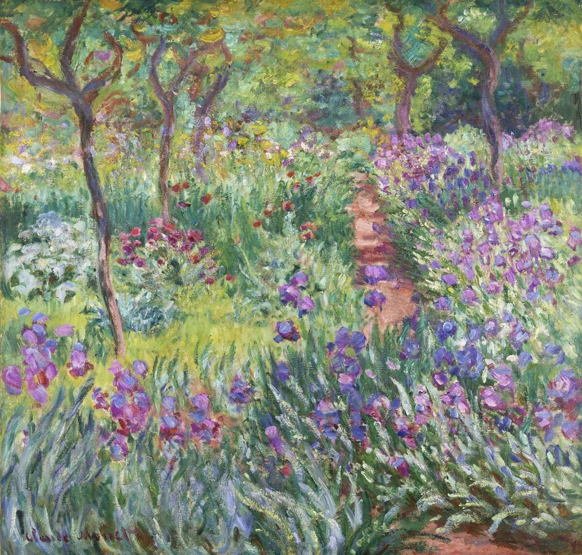 This undated photo provided by the New York Botanical Garden shows Claude Monet's painting, "The Artist's Garden in Giverny," which is on display in a new exhibition at the New York Botanical Garden, in New York. Monet once said he owed becoming a painter to his love for flowers and the exhibit explores the French impressionist artist's passion for his beloved water lilies, irises and gardens and how they influenced his art. (AP Photo/New York Botanical Garden)