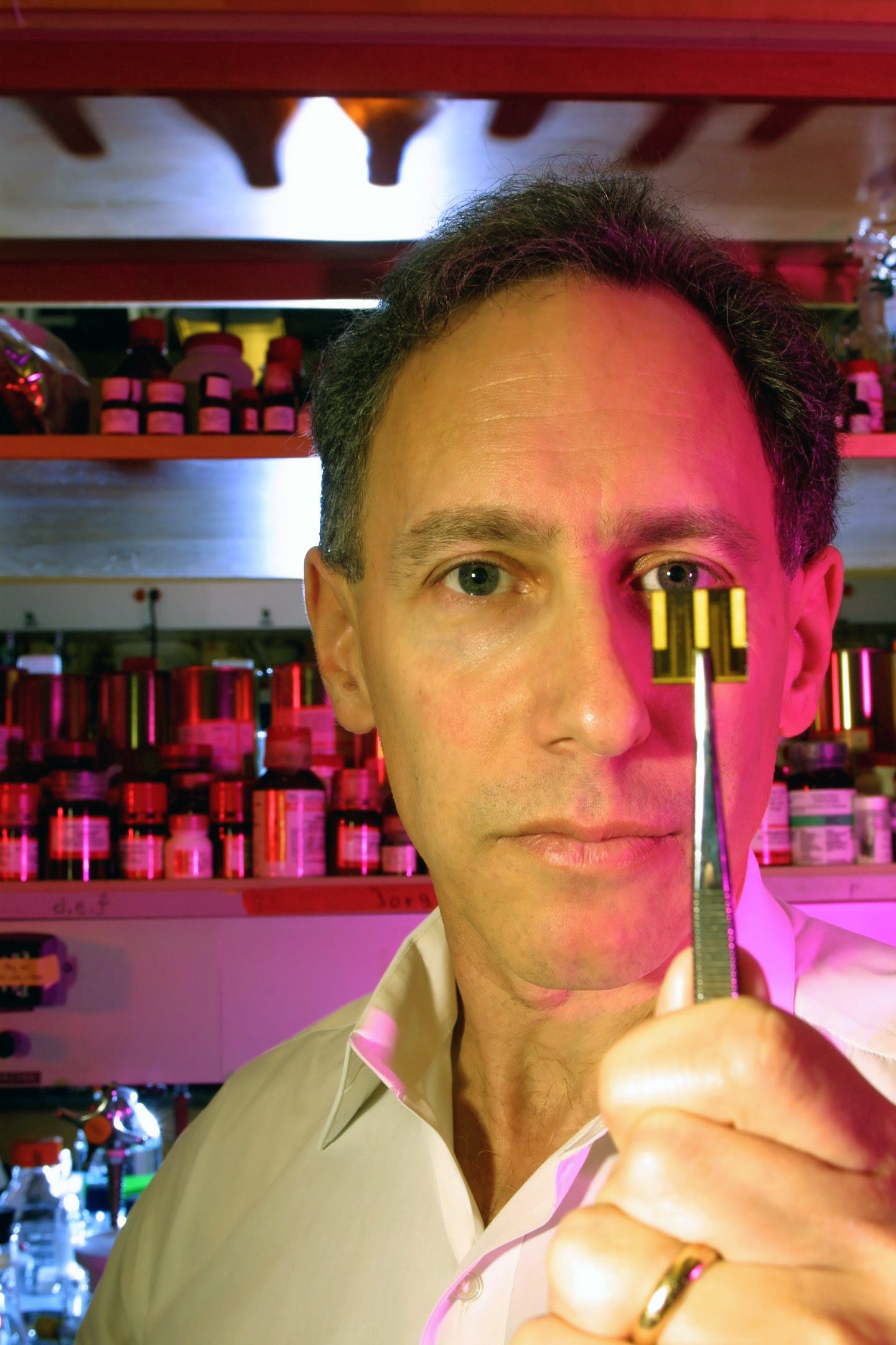 Professor Robert Langer displays one of the implant devices he has invented to deliver medication. (© Rick Friedman/Corbis)