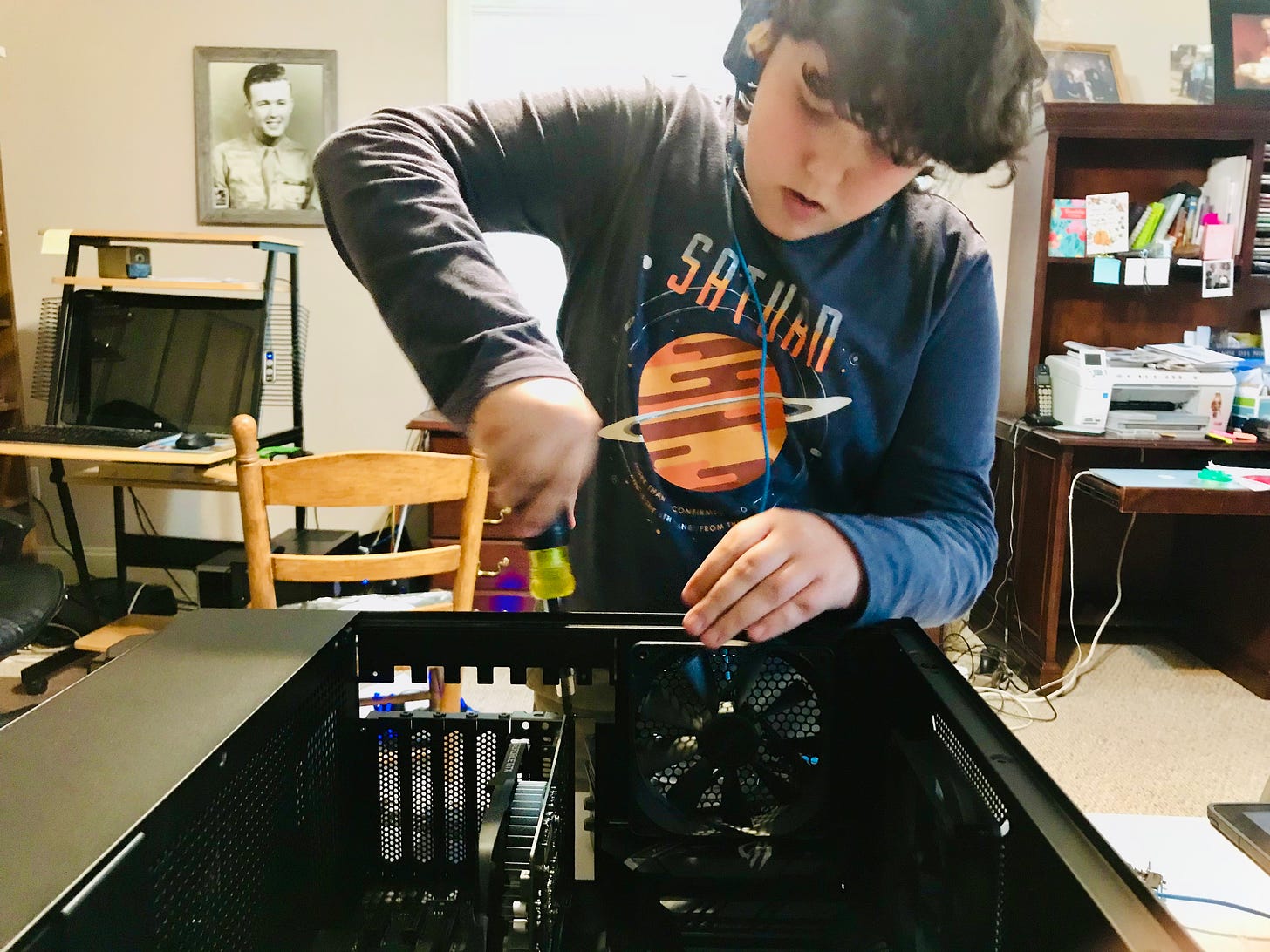 A teenager works on a computer