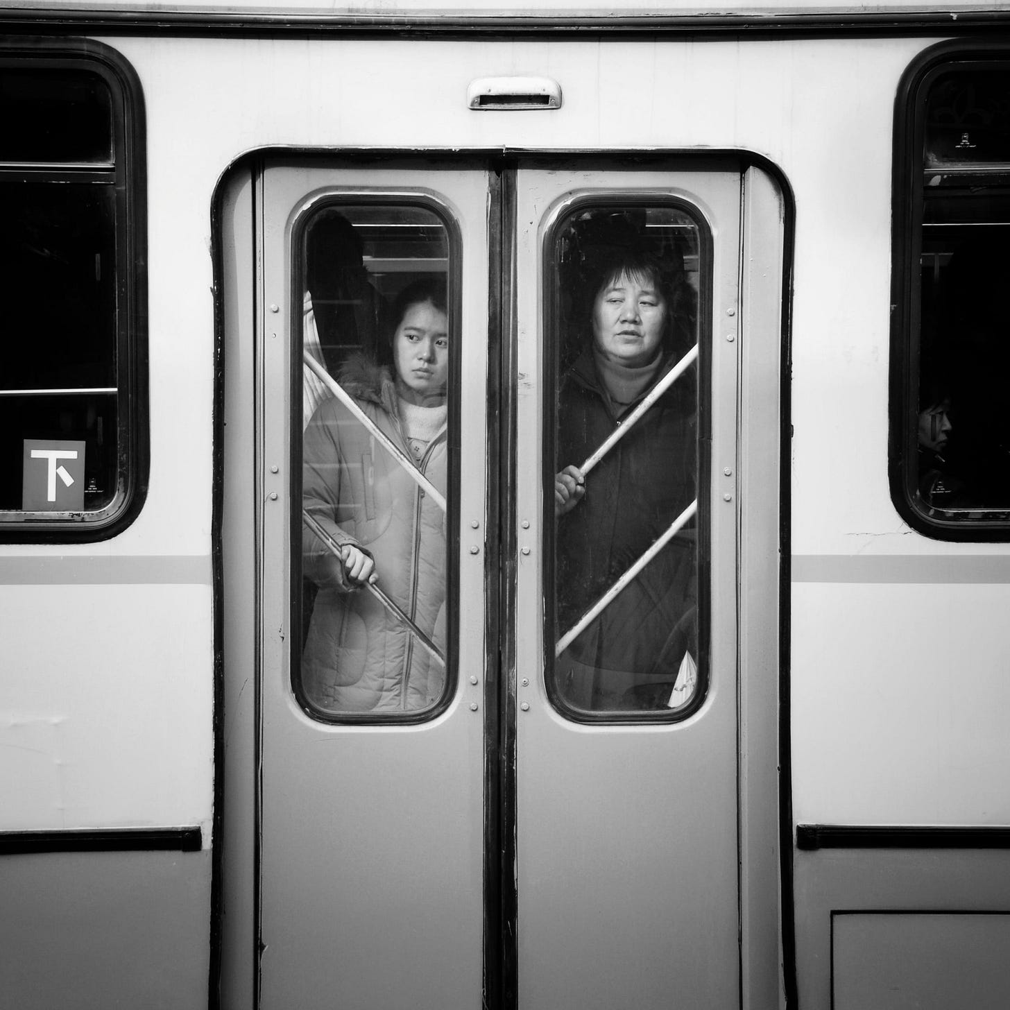 Passengers standing by the door of a crowded bus in downtown Beijing.