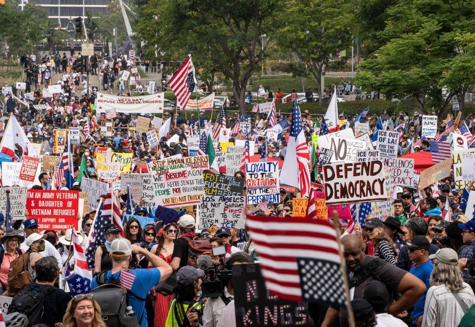 Protestors marching with signs against the president and military parade.