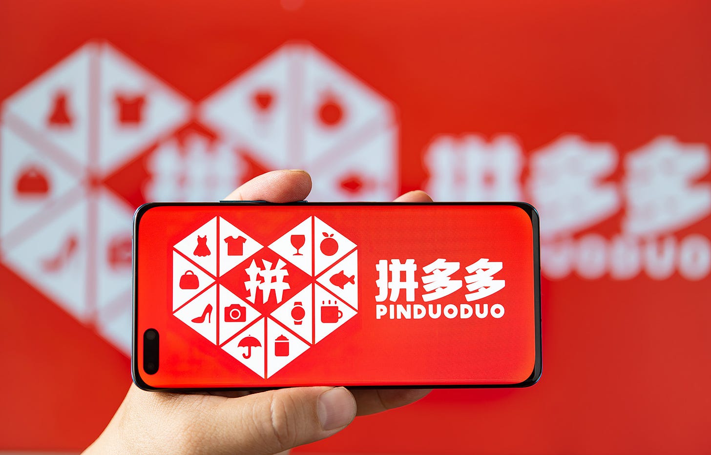 The Pinduoduo logo on a cell phone.